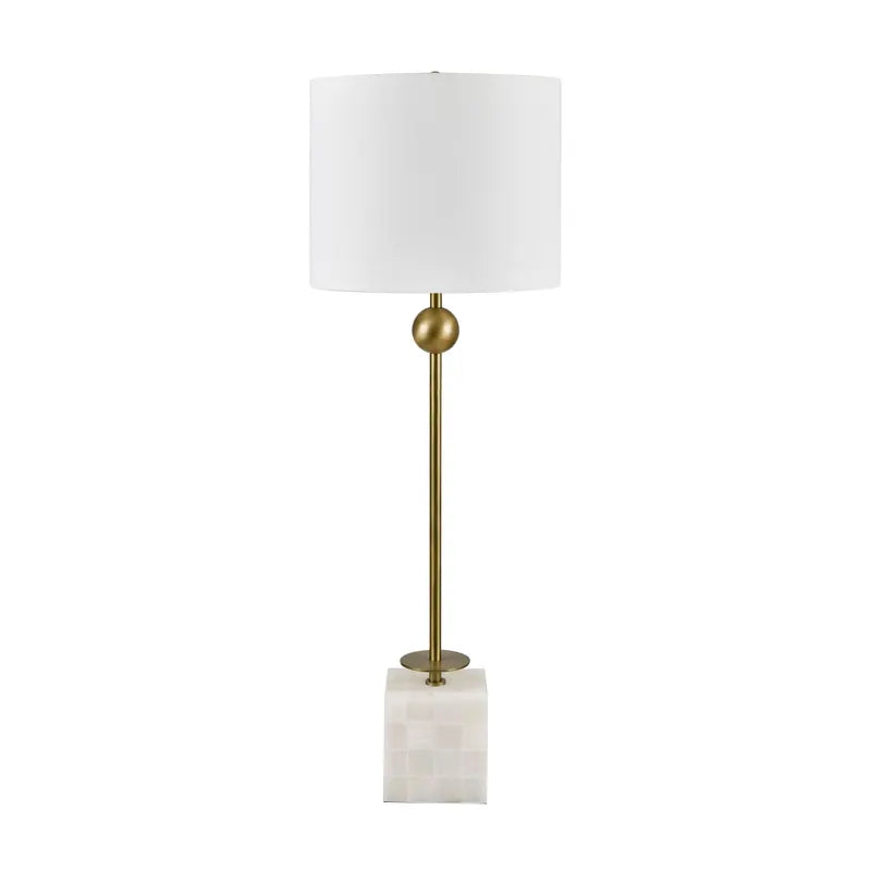 Table lamp with white shade, gold base, and marble square base on a white background