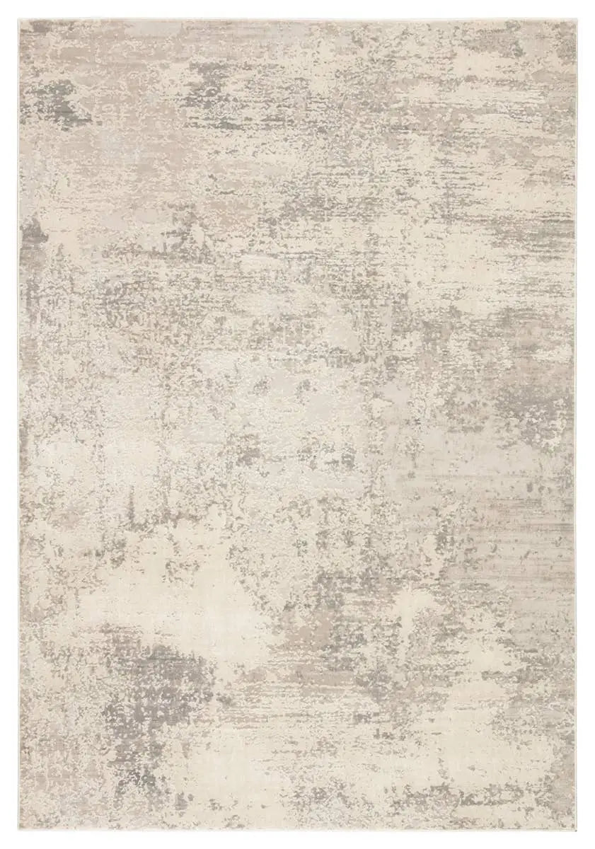 A power loomed area rug with a textured design in beige and gray tones.