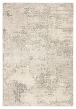 A power loomed area rug with a textured design in beige and gray tones.