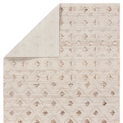 Beige patterned rug with a subtle design on a plain background