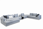 Gray sectional sofa with cushions on a white background