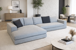 Modern living room with a light gray sectional sofa, coffee table, and decorative items.