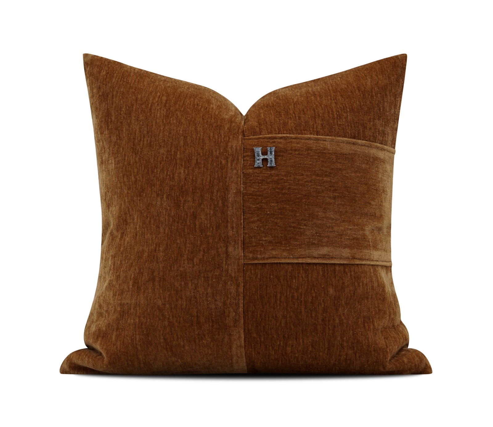 A square brown velvet throw pillow with a central horizontal seam and a small silver 'H' logo, shown on a white background with a light gray footer containing the brand name 'YMXBY'.