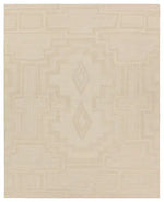 Beige area rug with geometric pattern on a plain background