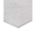 A rectangular area rug with a textured white design, featuring a subtle pattern.