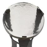 Round metallic object with a reflective surface on a white background