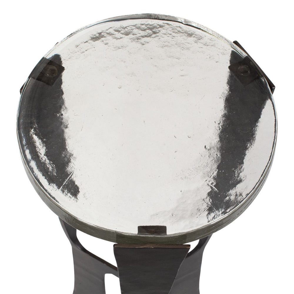 Round metallic object with a reflective surface on a white background