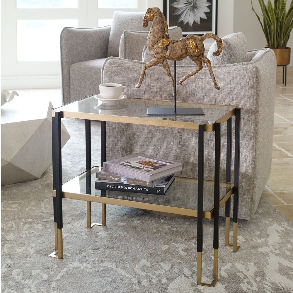 Modern side table with books and a coffee cup in a living room setting