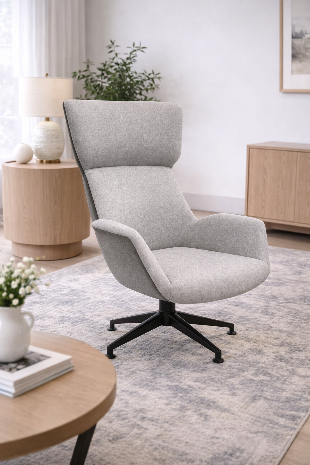 Gray armchair in a modern living room with a side table and rug.