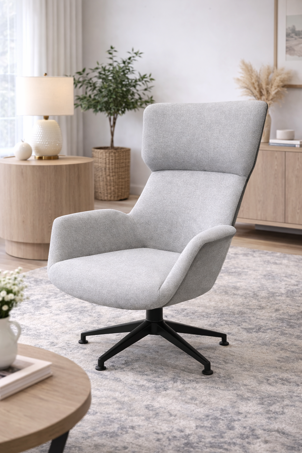 Gray armchair in a modern living room with a lamp, plant, and side table.