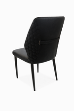 Black upholstered chair with quilted backrest on a white background