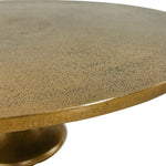 Round marble table with a gold base on a white background