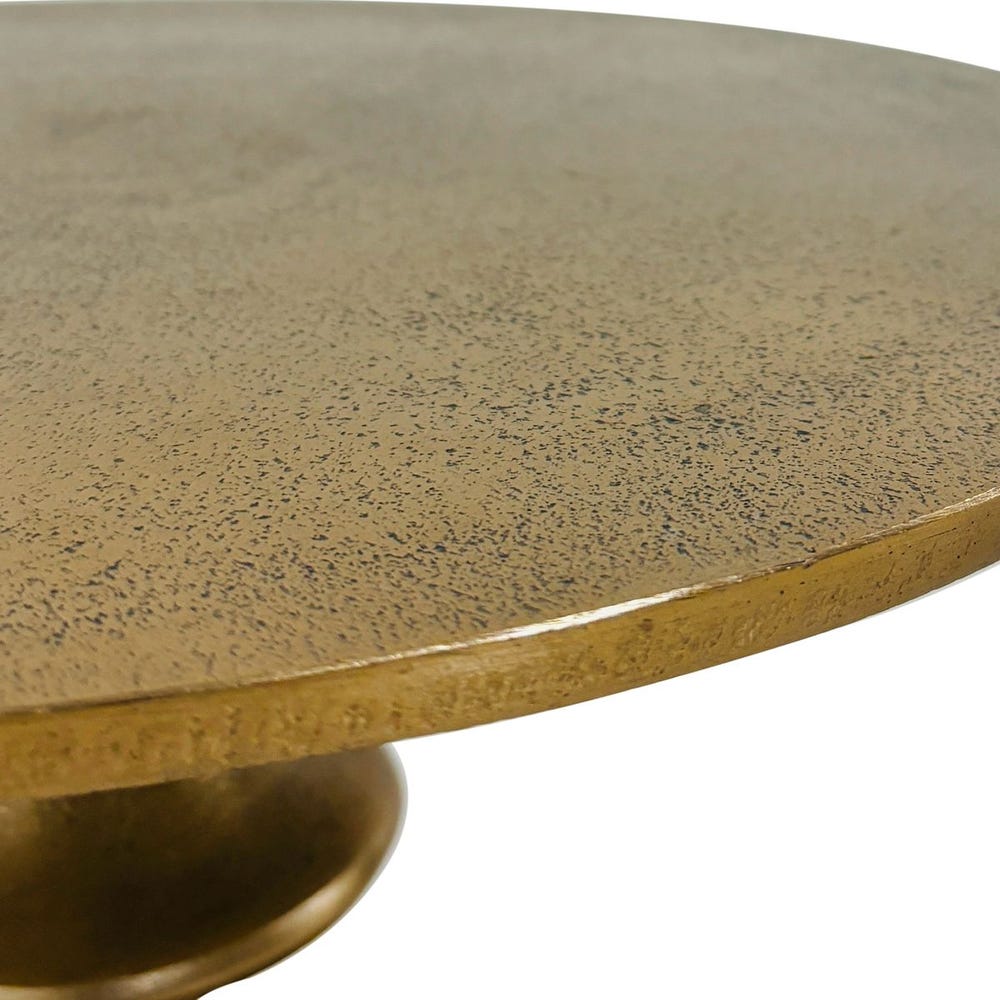 Round marble table with a gold base on a white background