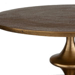 Round table with textured surface and bronze base on a white background