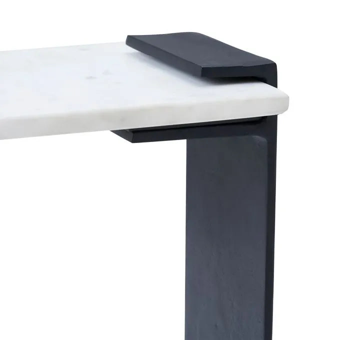 An end table with a black matte finish leg and a natural white marble top.