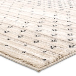 Beige rug with black pattern on a white background