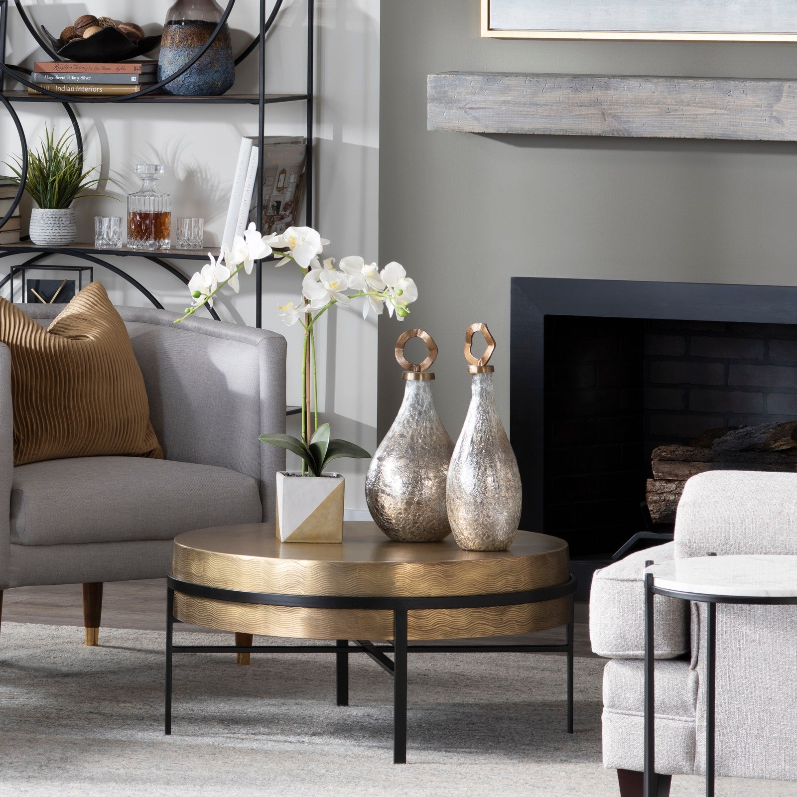 Living room with a coffee table, decorative vases, and a fireplace.