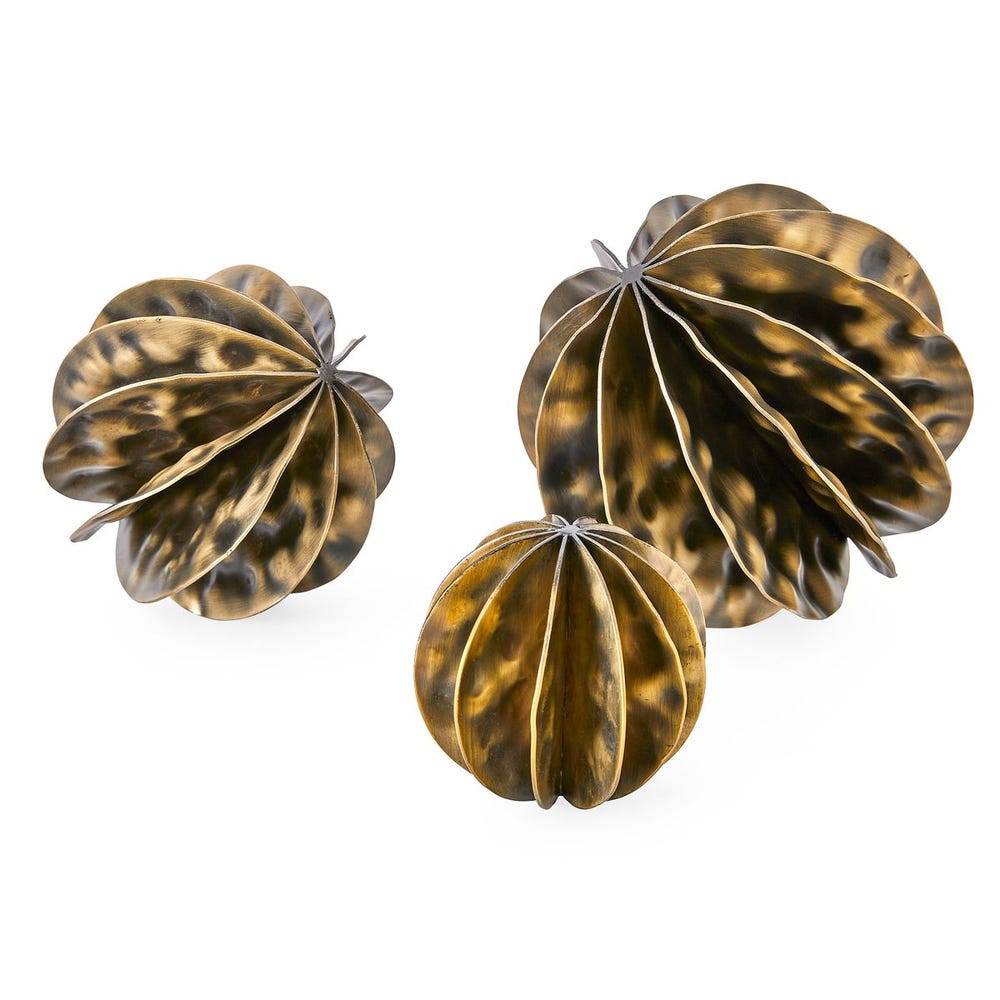 Set of three bronze-colored decorative items on a white background