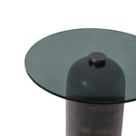Glass table with a dark metal base on a white background