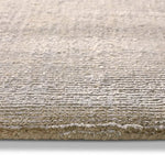 Close-up of a textured beige rug on a white background