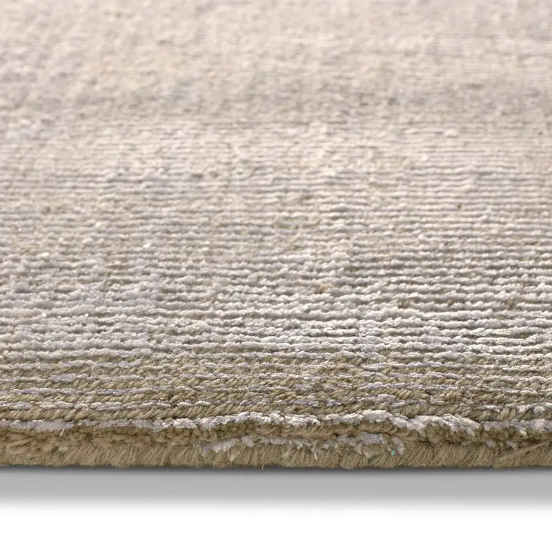 Close-up of a textured beige rug on a white background