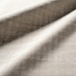 Close-up of textured beige fabric with a subtle pattern