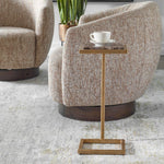 Beige armchair with a small wooden side table and a cup on a white saucer.