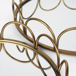 Two gold-colored metal serving trays with a geometric pattern.