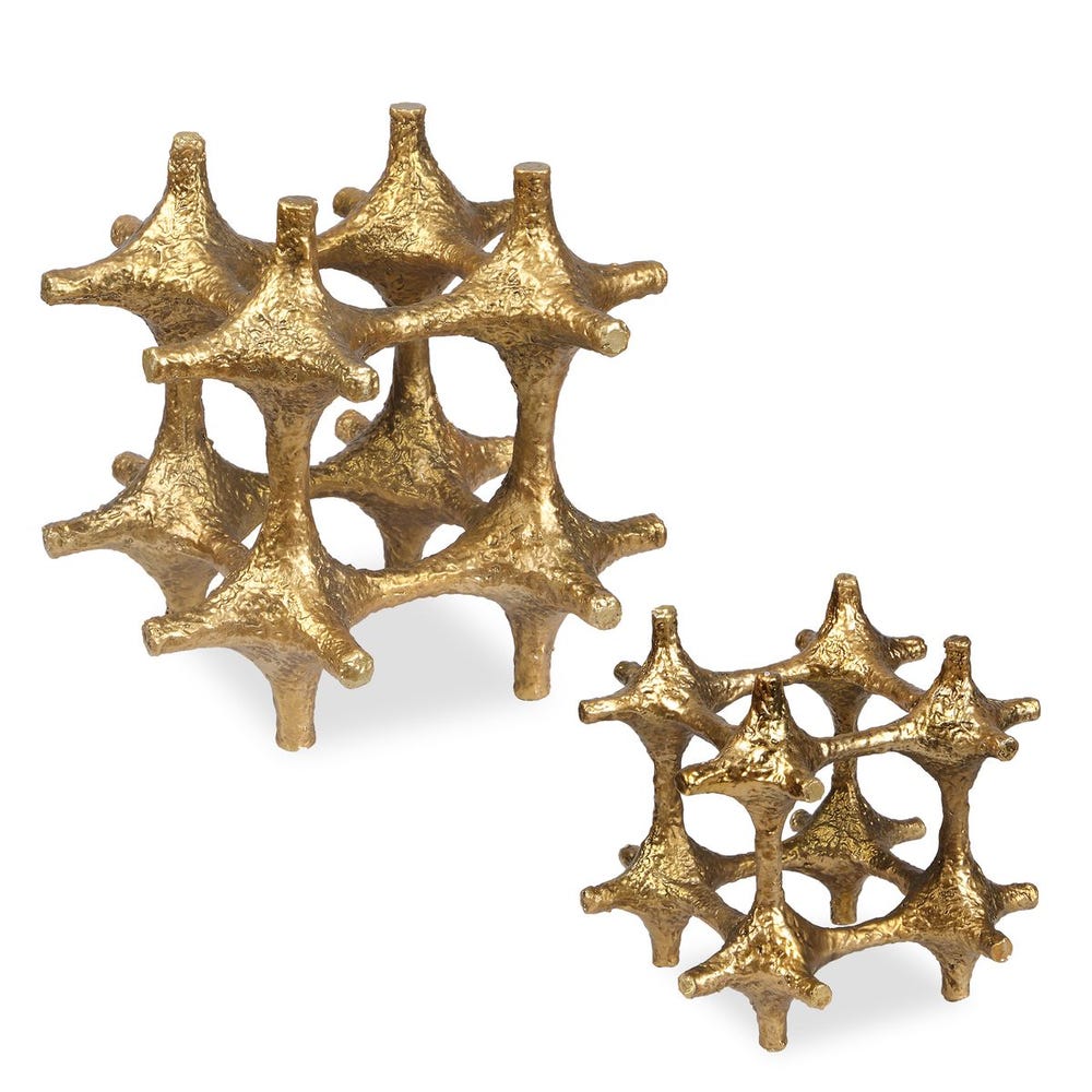 Pair of gold earrings with star-like design on a white background