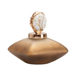 A gold-colored bottle accent with a textured surface and a rounded shape designed to sit on top of a bottle.