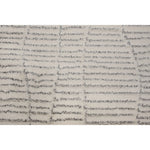 Textured area rug with a neutral color palette on a white background