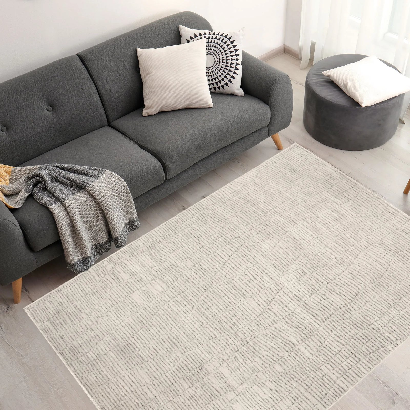 Textured area rug with a neutral color palette on a white background