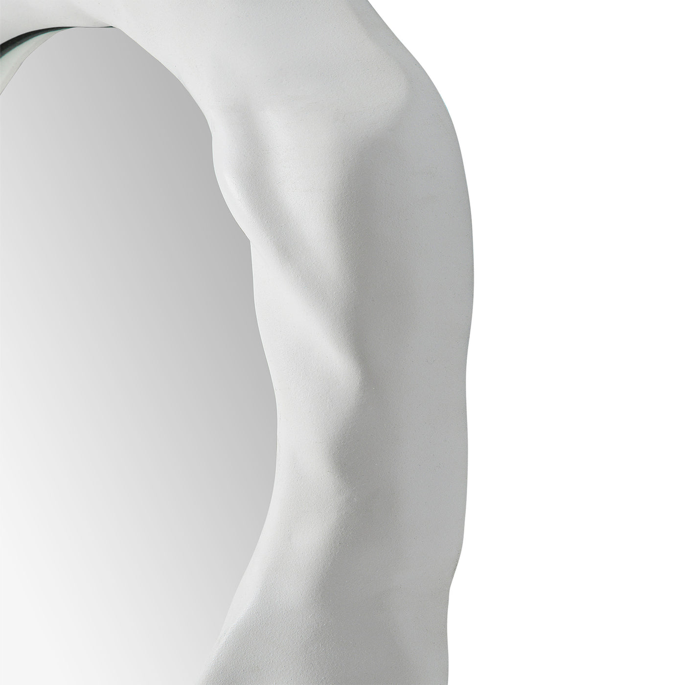 Close -up to a organic form mirror with a white background