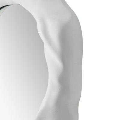 Close -up to a organic form mirror with a white background