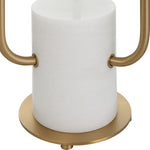 Gold paper towel holder with a white roll of paper towels on a white background