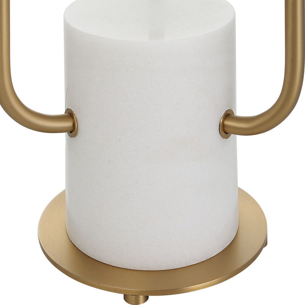 Gold paper towel holder with a white roll of paper towels on a white background