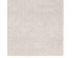 A light taupe area rug with a textured weave, handwoven from 100% pet yarn.