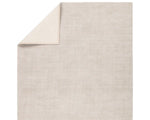 A light taupe area rug with a textured weave, handwoven from 100% pet yarn.