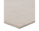 A light taupe area rug with a textured weave, handwoven from 100% pet yarn.