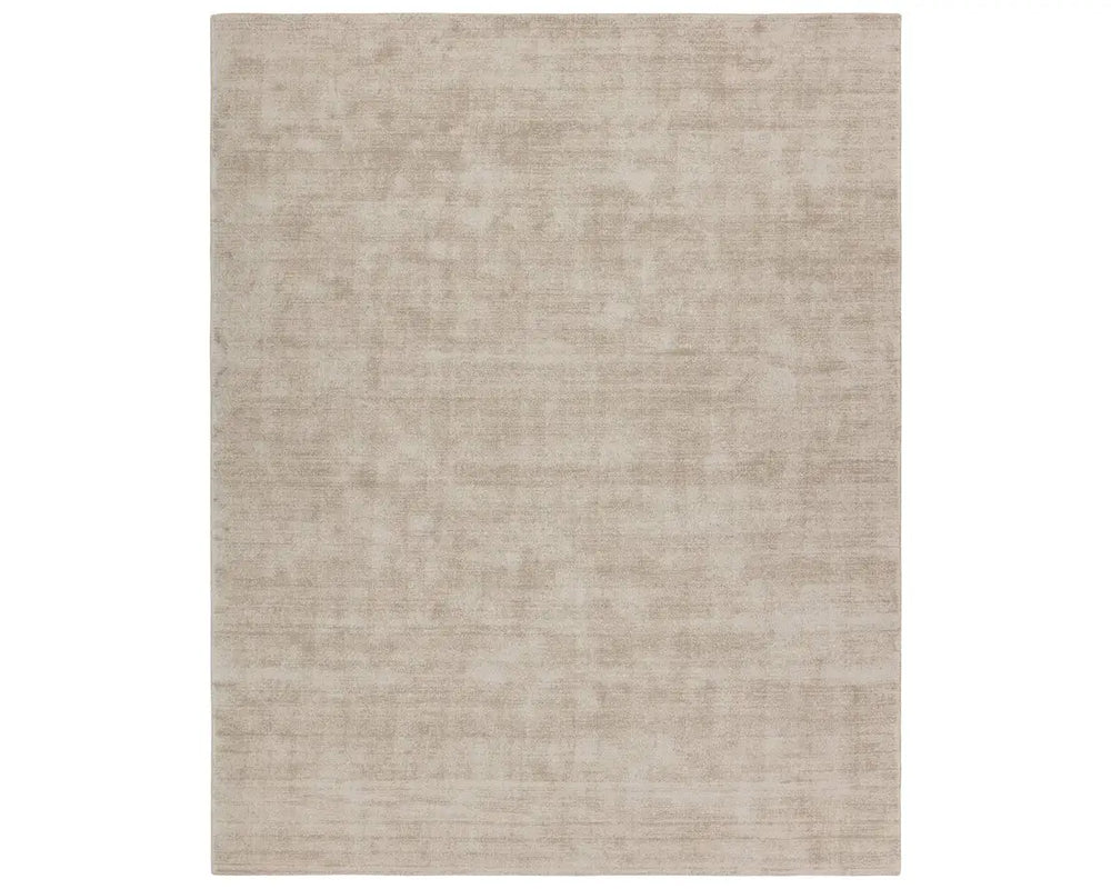 A rectangular taupe-colored area rug with a textured weave pattern.