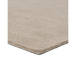 A rectangular taupe-colored area rug with a textured weave pattern.thickness