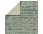 A rectangular, solid green area rug with a textured design.