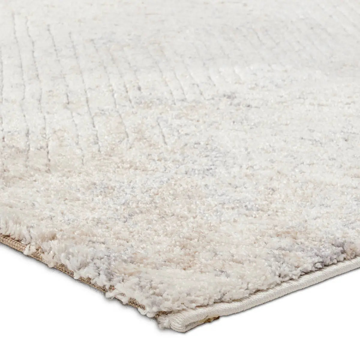 Close-up of a textured beige rug corner on a white background