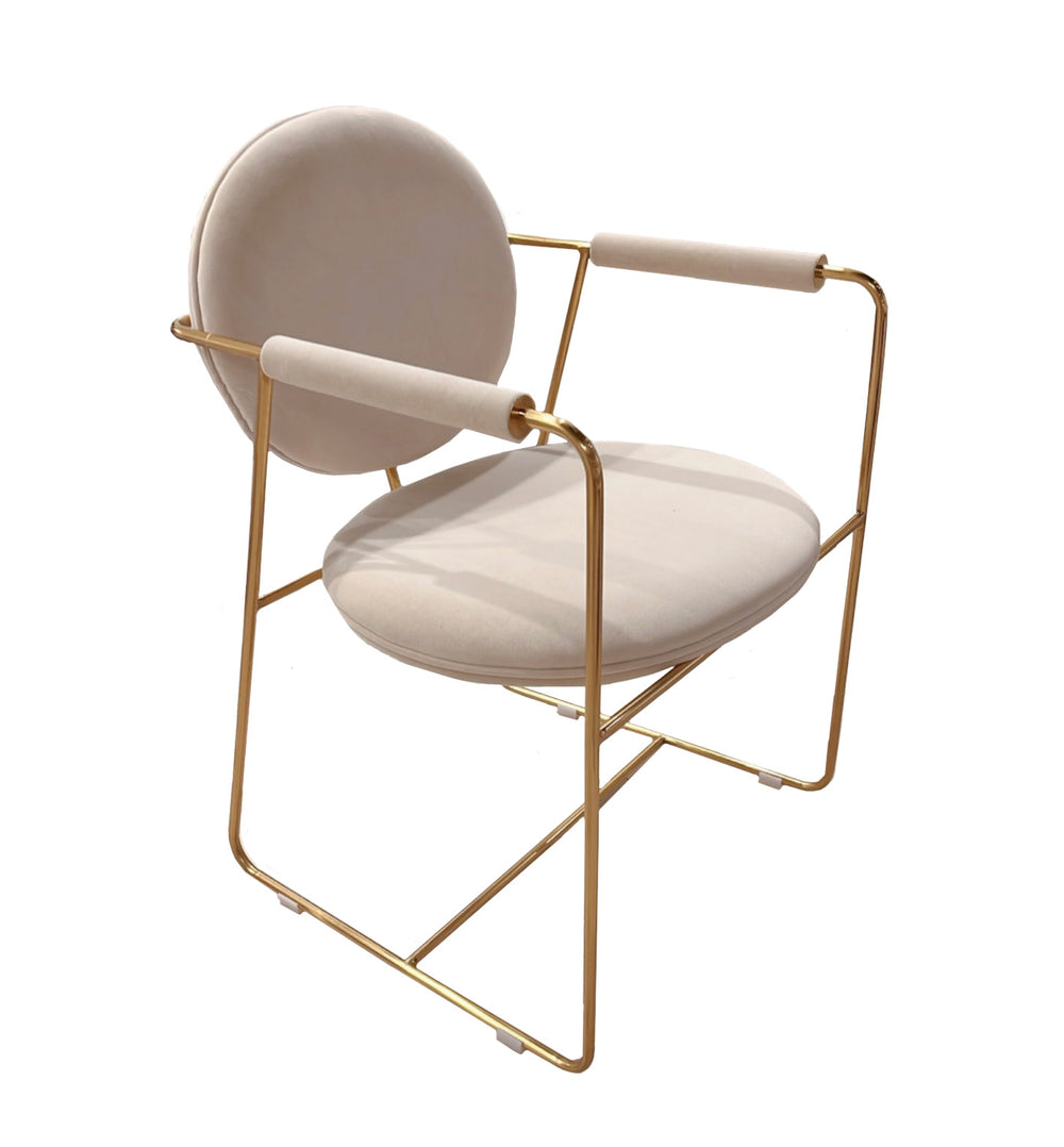 Modern chair with gold frame and beige cushion on a white background