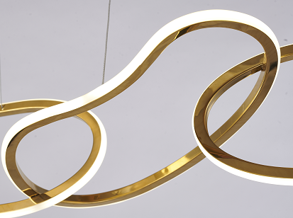 Three brass LED chandeliers with a modern design, featuring circular light covers and hanging from a bar with a beige background.