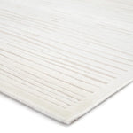 Close-up of a textured white rug with horizontal lines on a white background