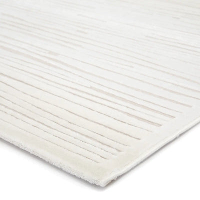 Close-up of a textured white rug with horizontal lines on a white background