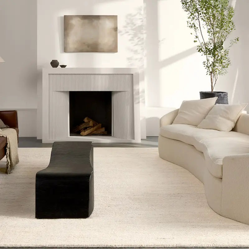 Modern living room with a fireplace, sofa, and decorative elements.