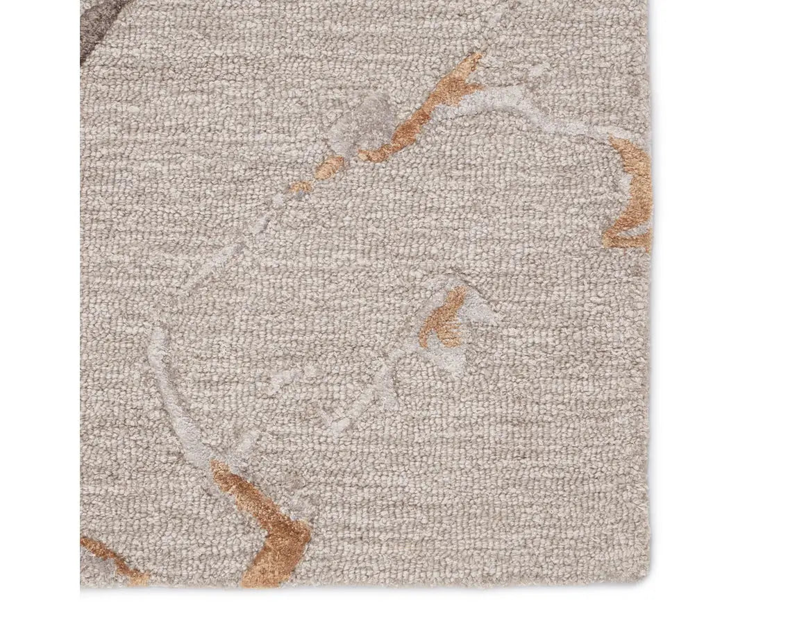 A dark dove and gold area rug with a textured surface featuring cracks and seams, resembling a natural stone or marble appearance.