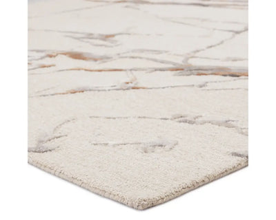 A rectangular area rug with a light gray color and a marble-like pattern, indicating a hand-tufted construction.